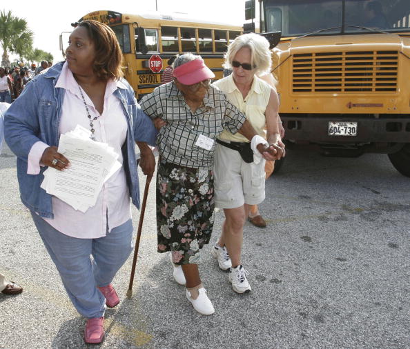 Old Woman Being Assisted To Walk