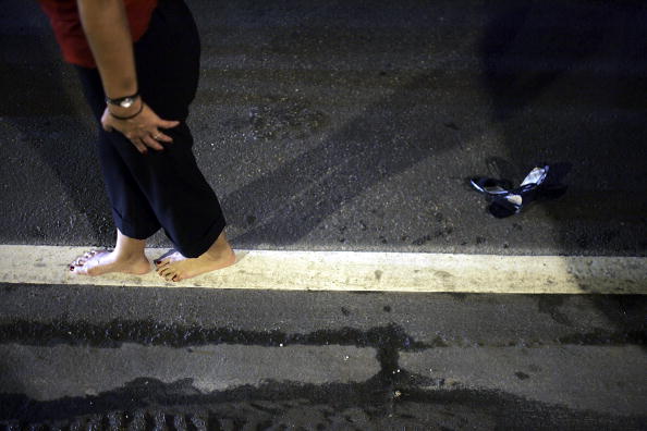 A woman (not the woman in the article) takes a roadside sobriety test by being asked to walk straight along a line. A woman (not the woman in the article) takes a roadside sobriety test by being asked to walk straight along a line.