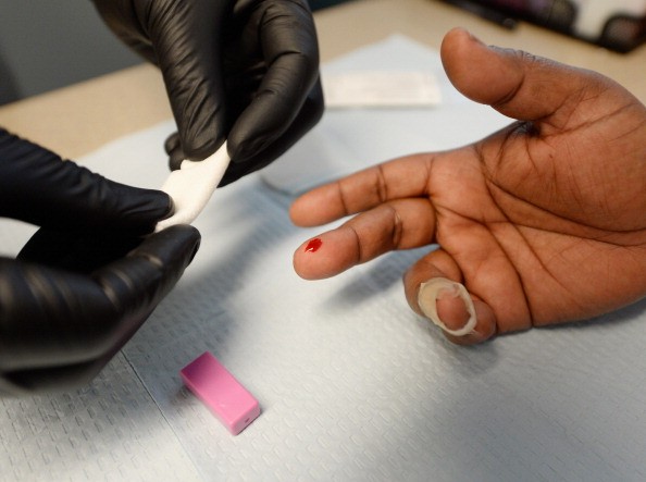 A woman has blood drawn for an HIV test. 