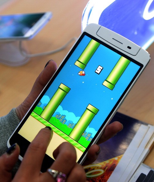 An employee plays the game Flappy Bird