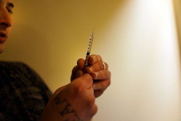 An intravenous drug user preparing to shoot up. 