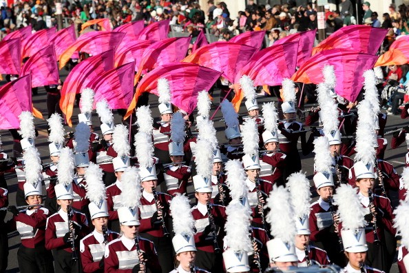 A high school marching band on parade. Being in a band can help in hearing and language skills. 