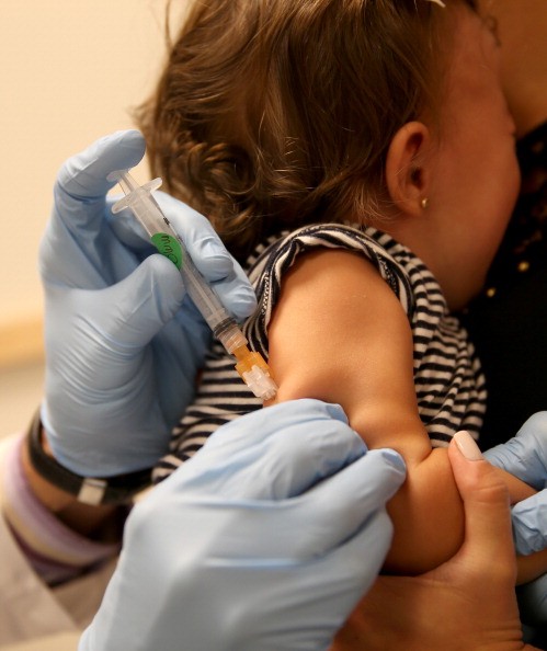 A child being vaccinated. Vaccination rates are high overall, but  pockets of the country havemany unprotected children