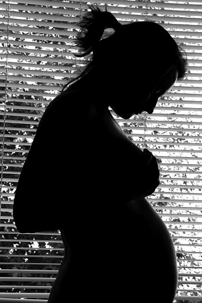 A woman six months pregnant.
