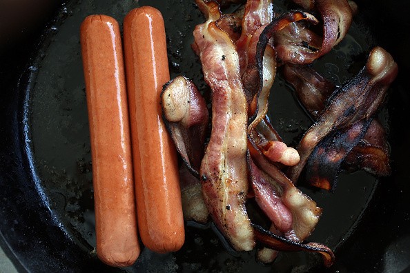 Processed meats, including hot dogs and bacon, raise the risk of developing certain cancers, according to the World Health Organization. 