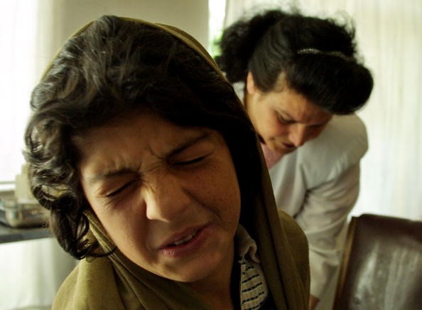 Afghan Woman Winces As She Receives A Painful Injection To 