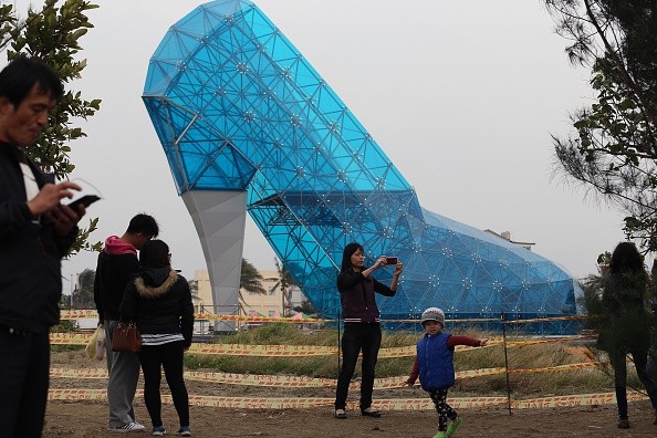 People taking photos of the glass slipper-like church in Taiwan 