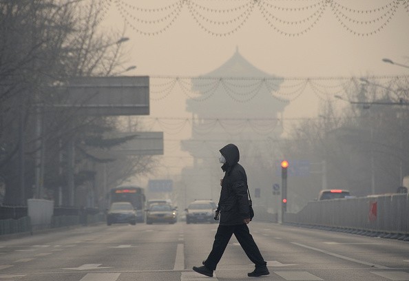 A pedestrian walks amid heavy smog in Beijing