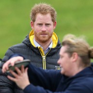 Prince Harry watches a competitor throw the discus at the Invictus Games Orlando British team trials at the University of Bath on January 29, 2016 in Bath, England.