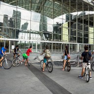 teenagers (not associated with the story) sit on bicycles outside the Marina Bay Sands hotel and casino in Singapore