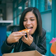 Photo of Woman Eating Pizza