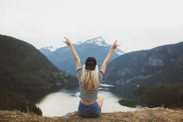 woman sitting on cliff