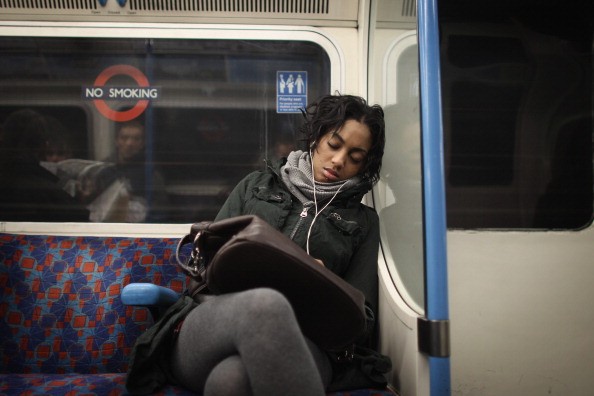Commuters Sleep On The Tube