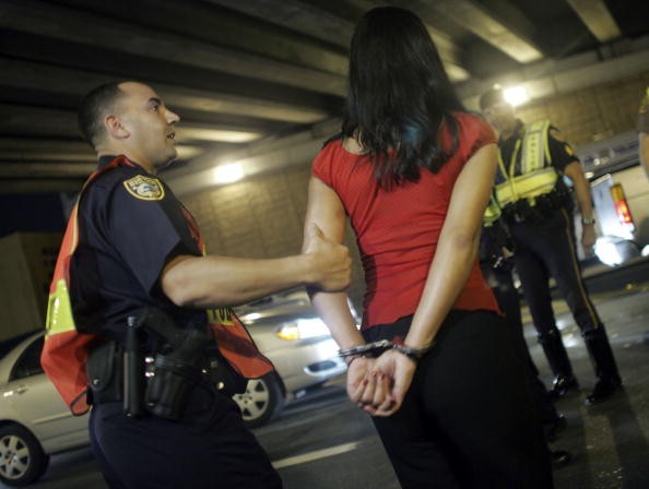 A Miami Beach police officer arrests a driver after she failed a sobriety test. 